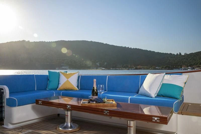 a table with a glass and a bottle on it aboard ALECTO Yacht for Sale