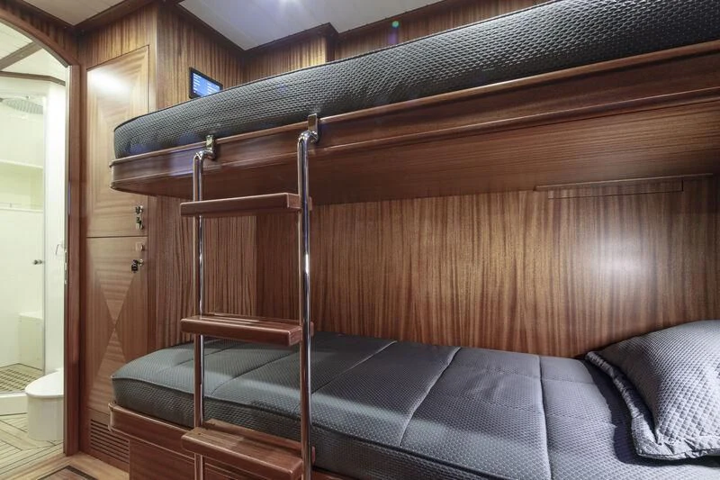a bunk bed with a blue sheet aboard ALECTO Yacht for Sale