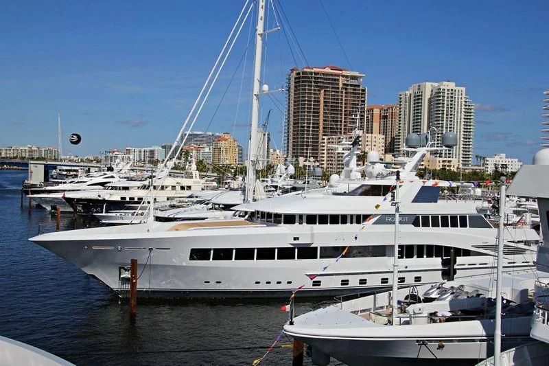 a large white boat in a harbor aboard ROCK.IT Yacht for Charter