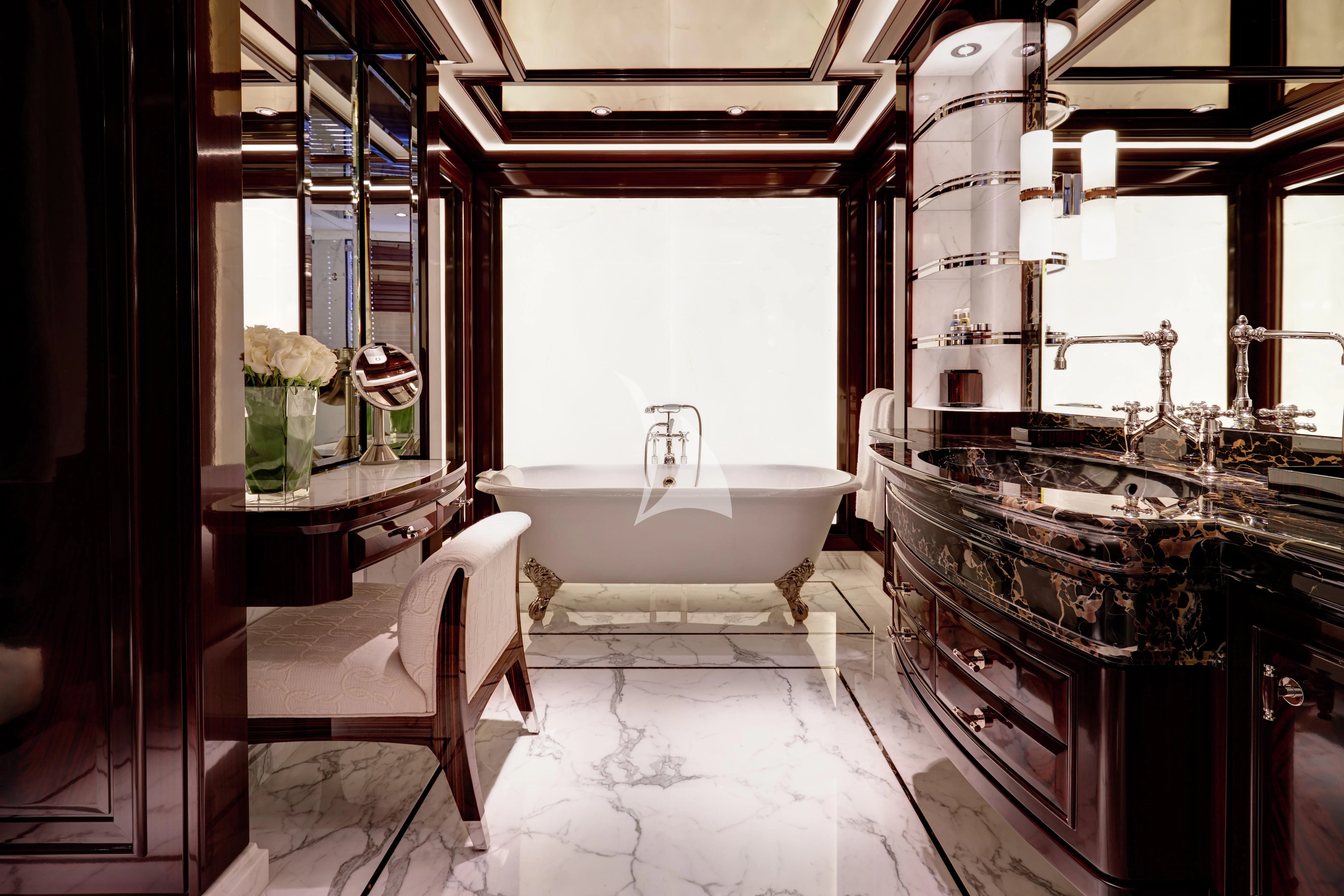 a bathroom with a tub sink and a mirror aboard ROCK.IT Yacht for Charter