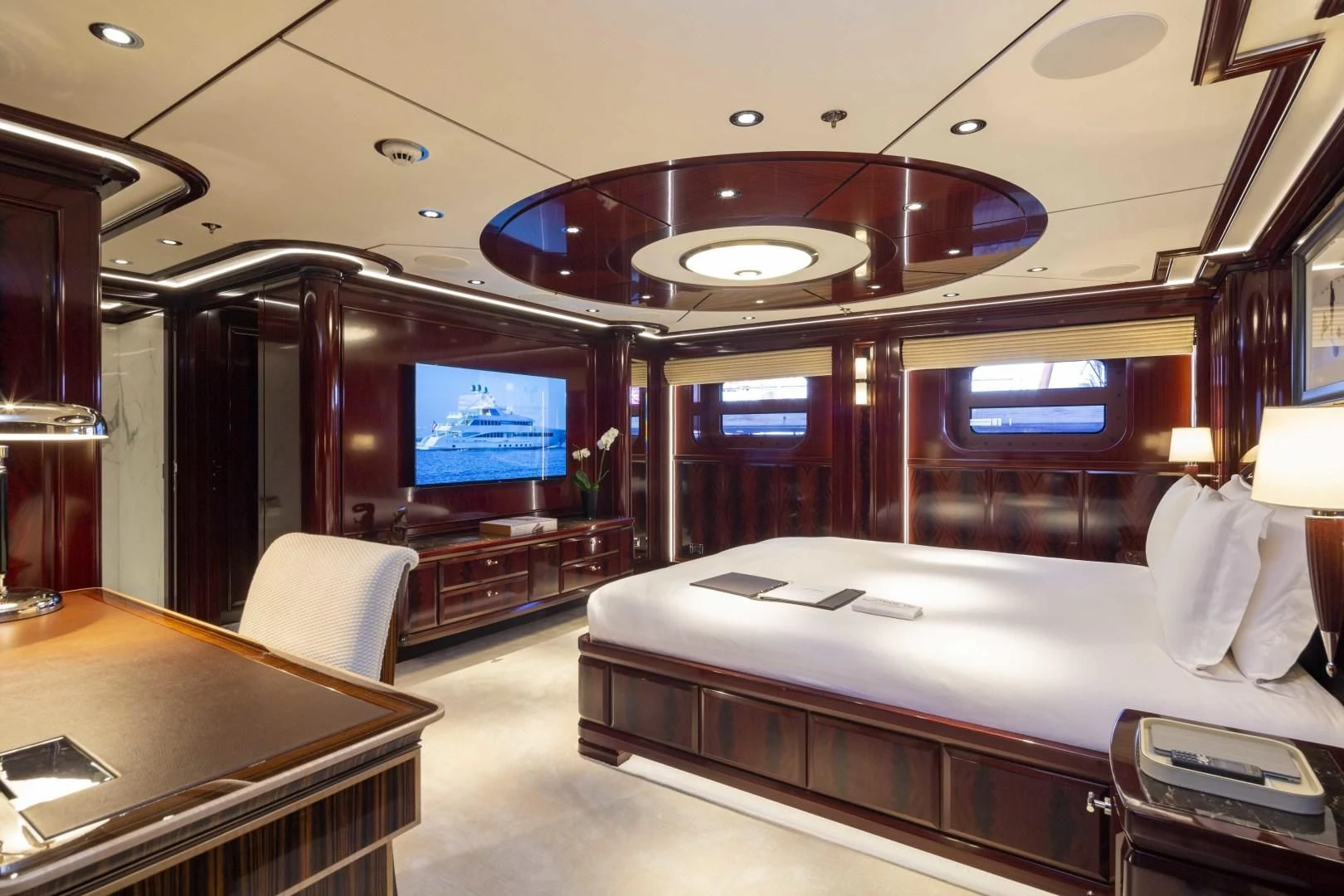 a room with a bed and a desk aboard ROCK.IT Yacht for Charter