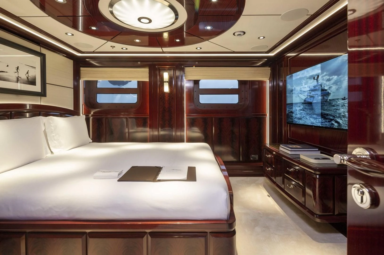 a room with a bed and a tv aboard ROCK.IT Yacht for Charter