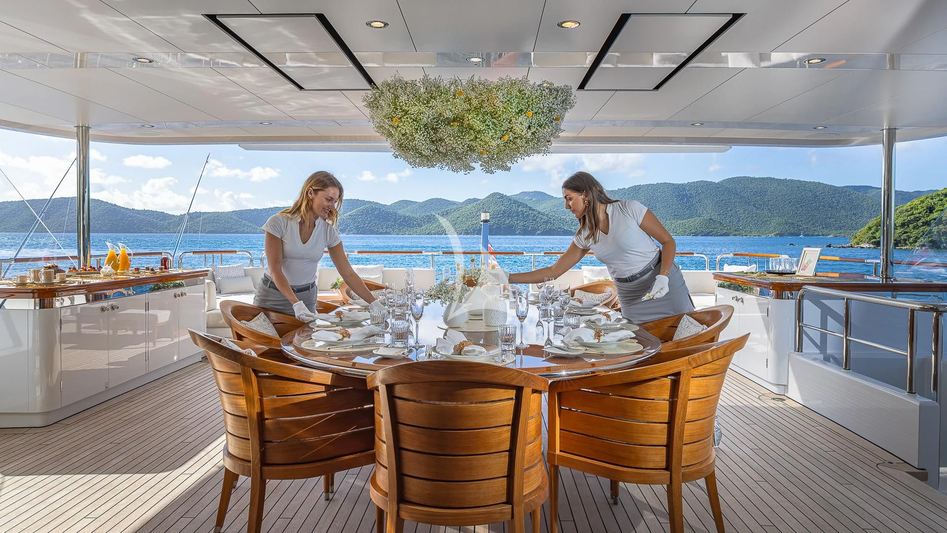 a couple of women cooking on a table aboard ROCK.IT Yacht for Charter