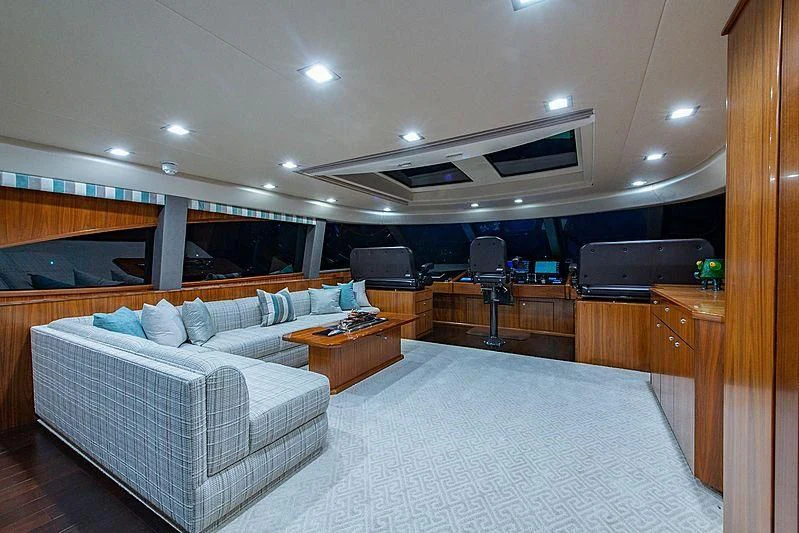 a room with a couch and a television aboard OBSESSION Yacht for Sale