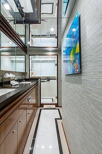 a kitchen with a painting on the wall aboard OBSESSION Yacht for Sale