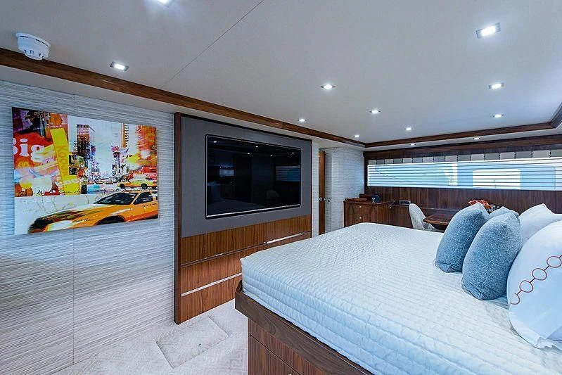 a bedroom with a bed and a television aboard OBSESSION Yacht for Sale