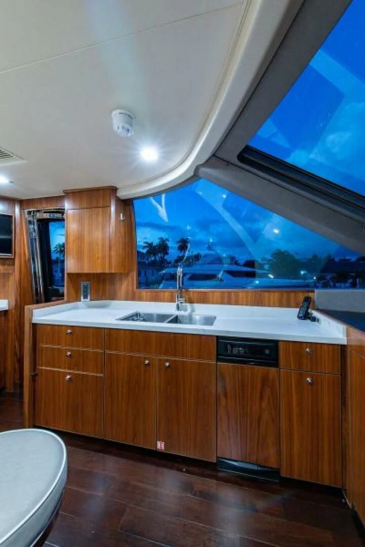 a kitchen with wooden cabinets aboard OBSESSION Yacht for Sale