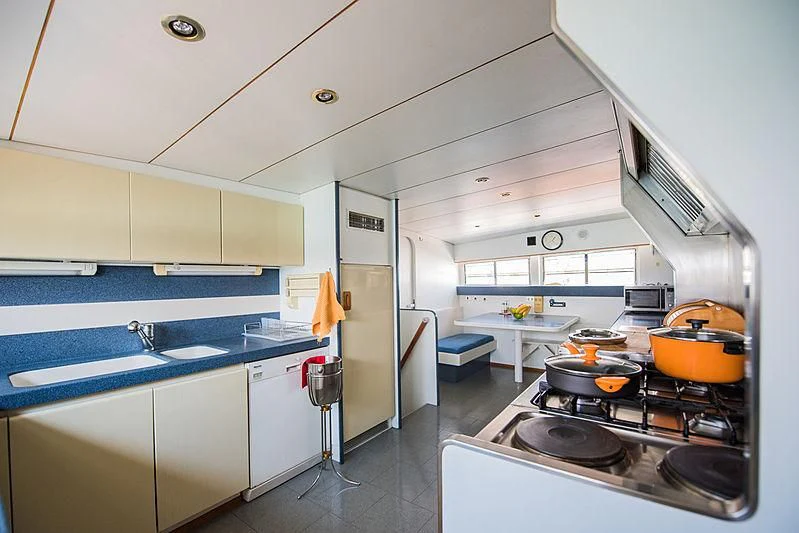 a kitchen with a stove and a sink aboard LADY RINA Yacht for Sale
