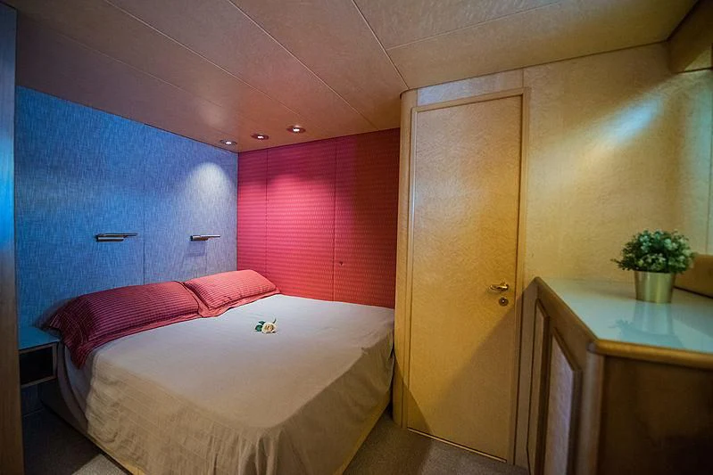 a bedroom with a desk and a bed aboard LADY RINA Yacht for Sale