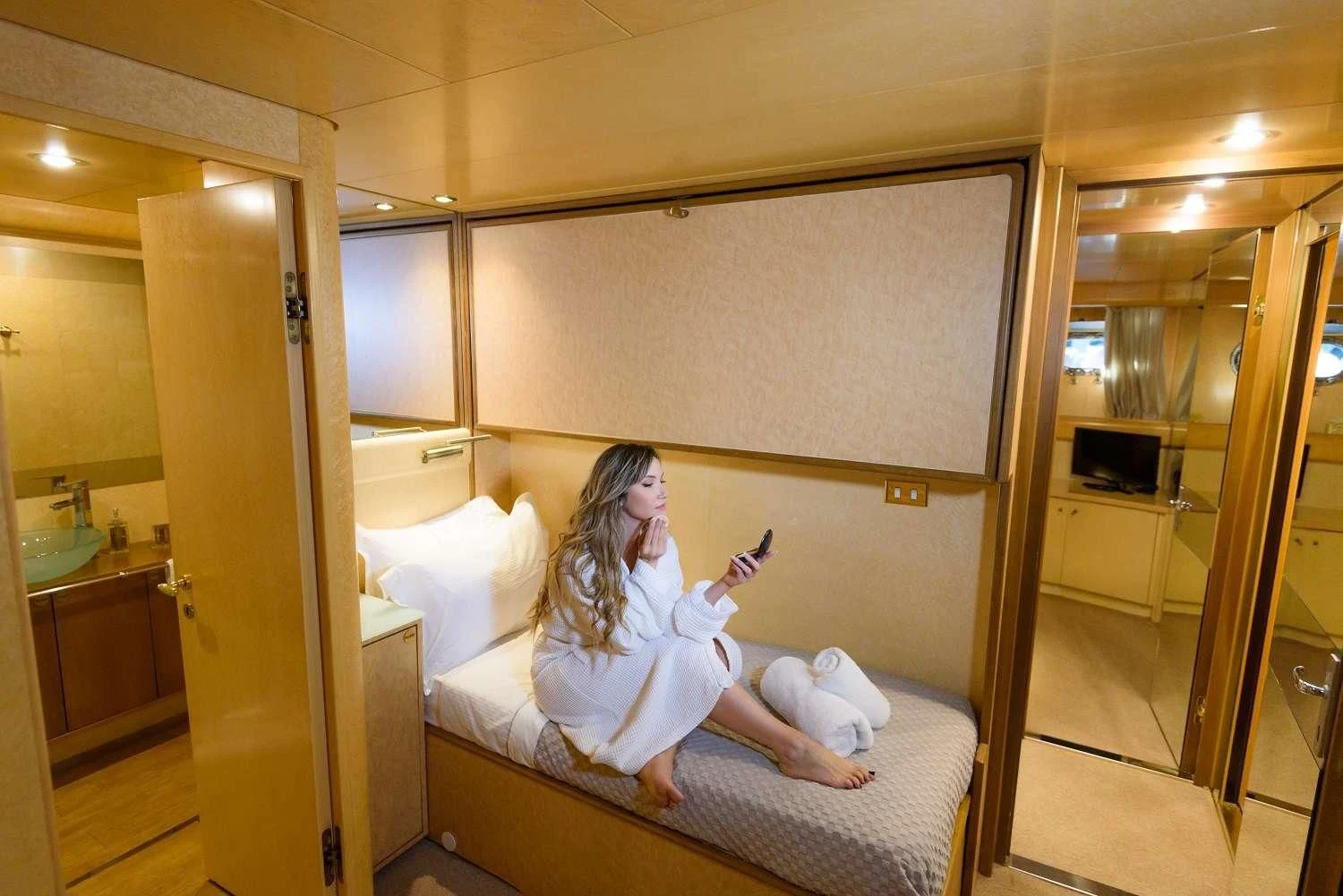 a person sitting on a bed aboard LADY RINA Yacht for Sale