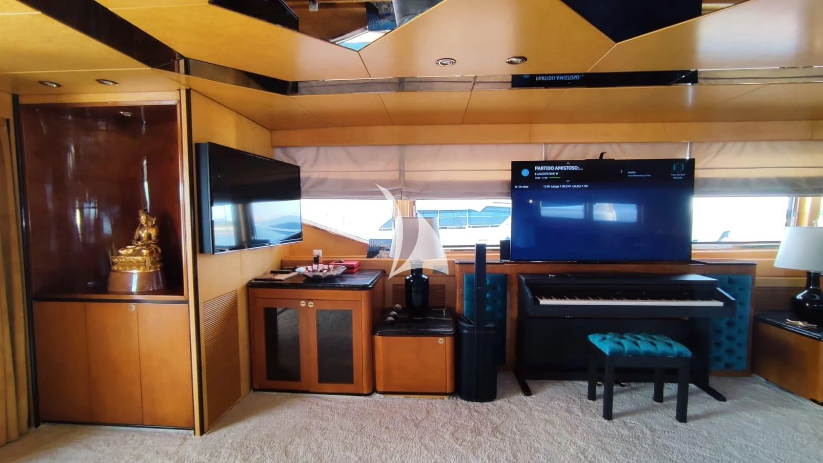 a room with a piano and a tv aboard LADY RINA Yacht for Sale