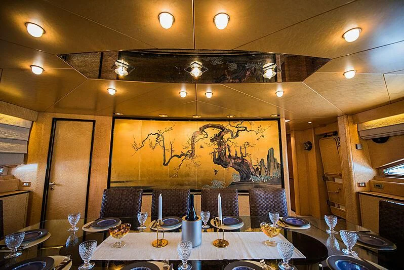 a room with a table and chairs aboard LADY RINA Yacht for Sale