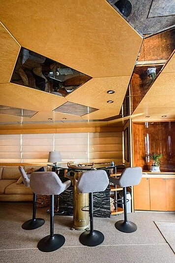 a room with a table and chairs aboard LADY RINA Yacht for Sale