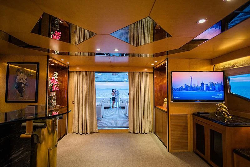 a room with a tv and a desk aboard LADY RINA Yacht for Sale