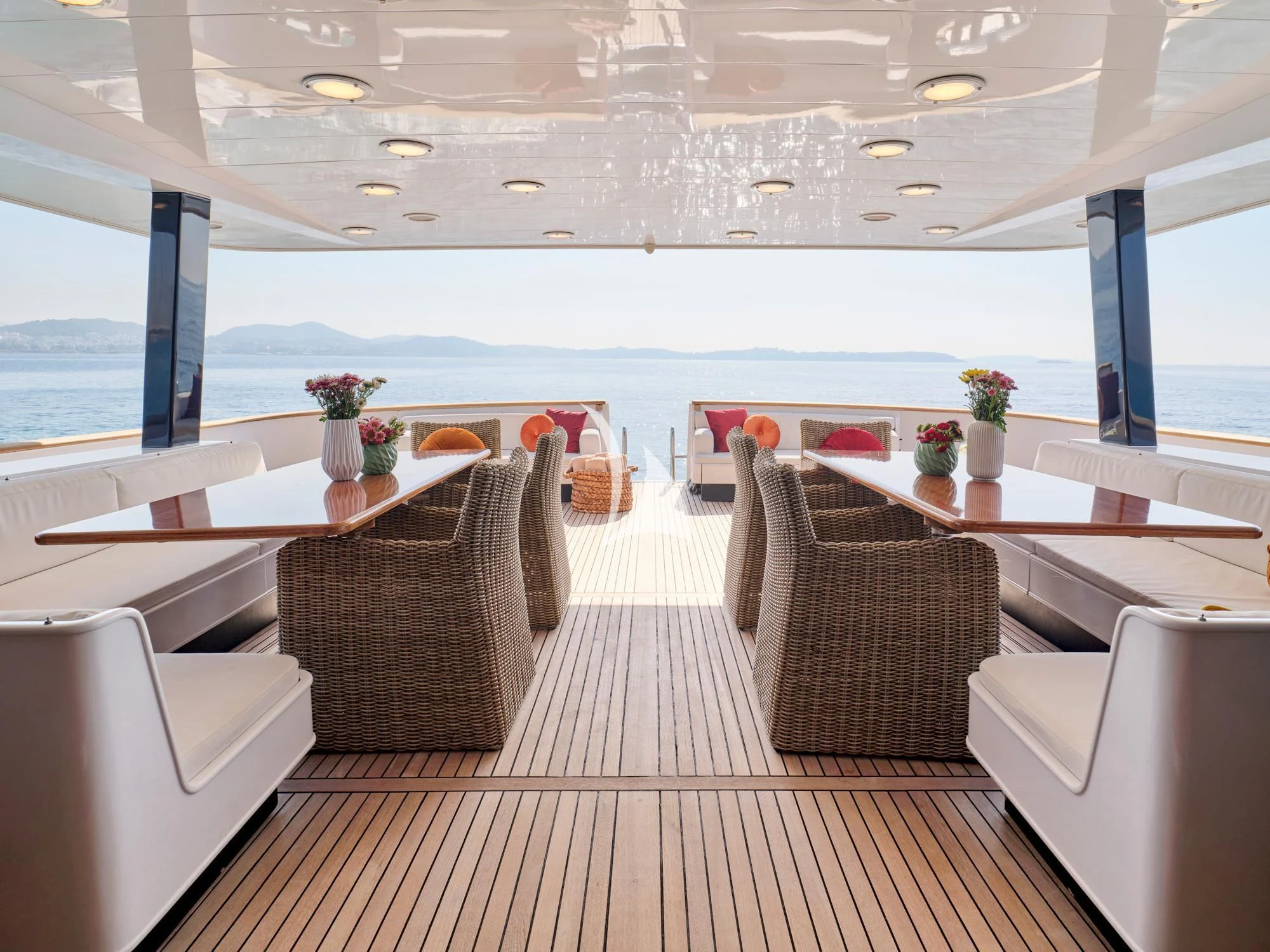 a room with a table chairs and a large window aboard LADY RINA Yacht for Sale