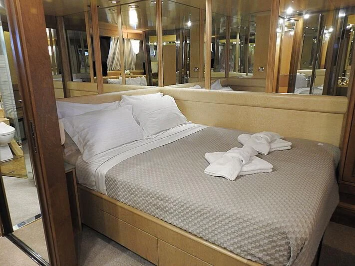 a bed with white sheets aboard LADY RINA Yacht for Sale