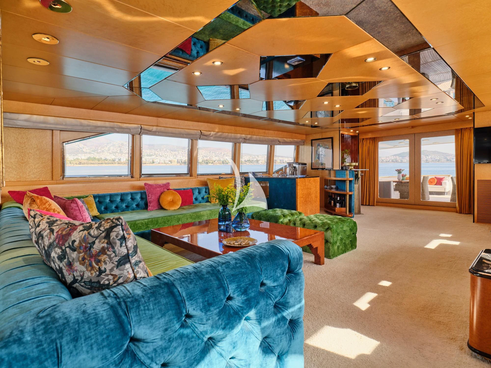 a living room with a couch and a coffee table aboard LADY RINA Yacht for Sale