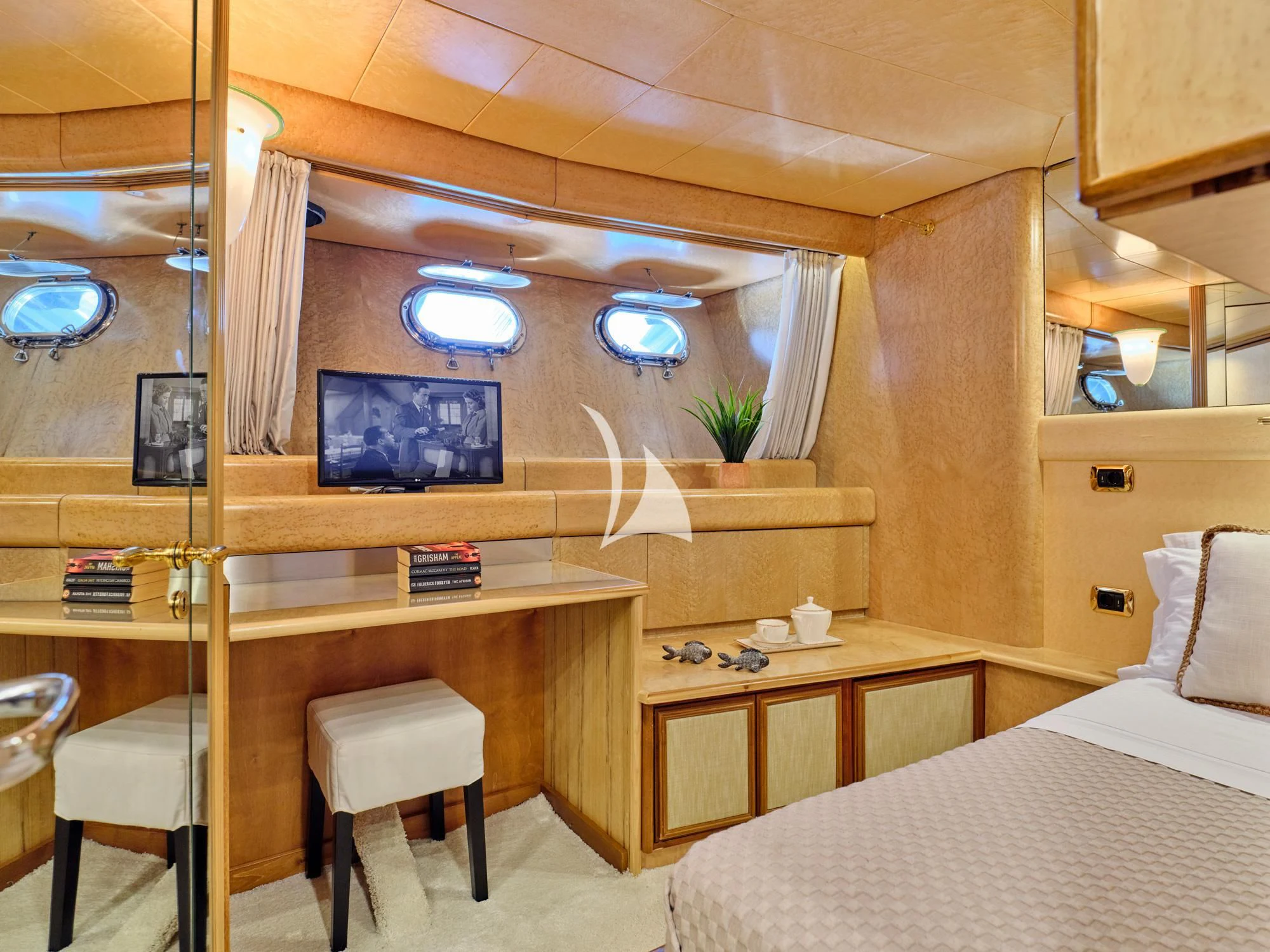a room with a bed and desk aboard LADY RINA Yacht for Sale