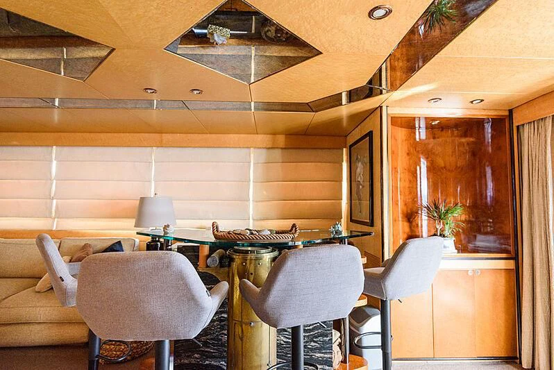 a room with a table and chairs aboard LADY RINA Yacht for Sale