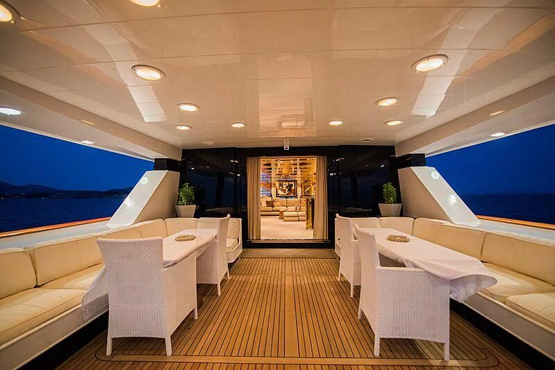 a room with a large white couch and a large screen television aboard LADY RINA Yacht for Sale