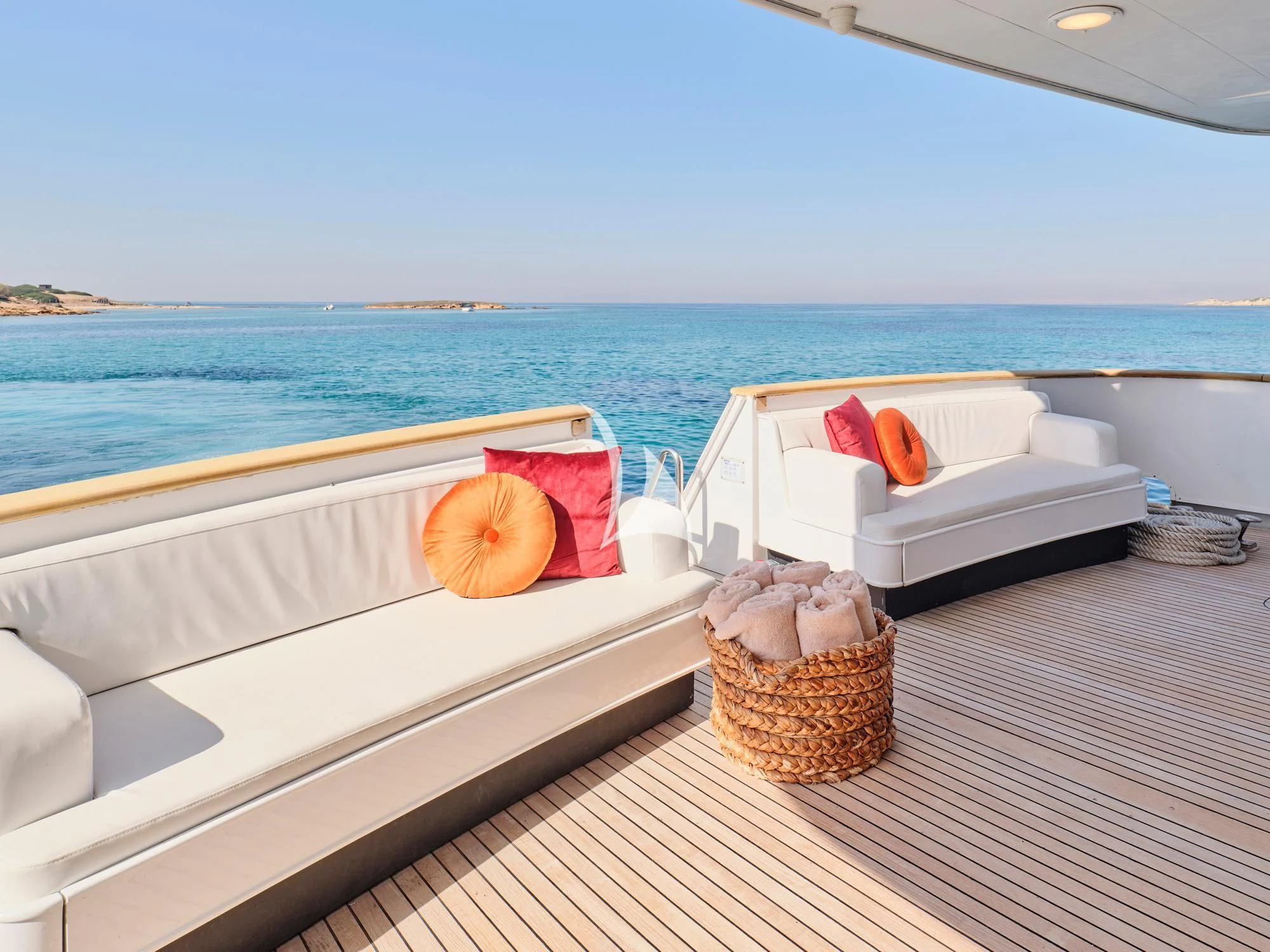 a white bed on a deck overlooking the ocean aboard LADY RINA Yacht for Sale