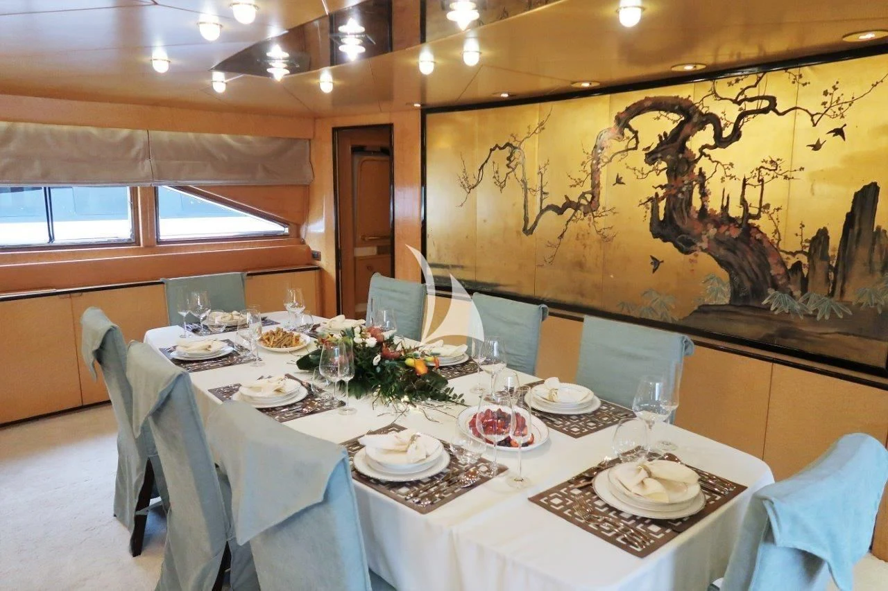a table set with plates and glasses aboard LADY RINA Yacht for Sale