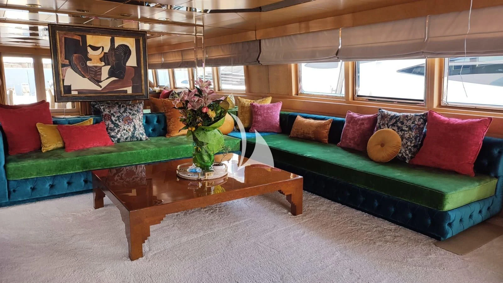 a living room with a couch and a coffee table aboard LADY RINA Yacht for Sale