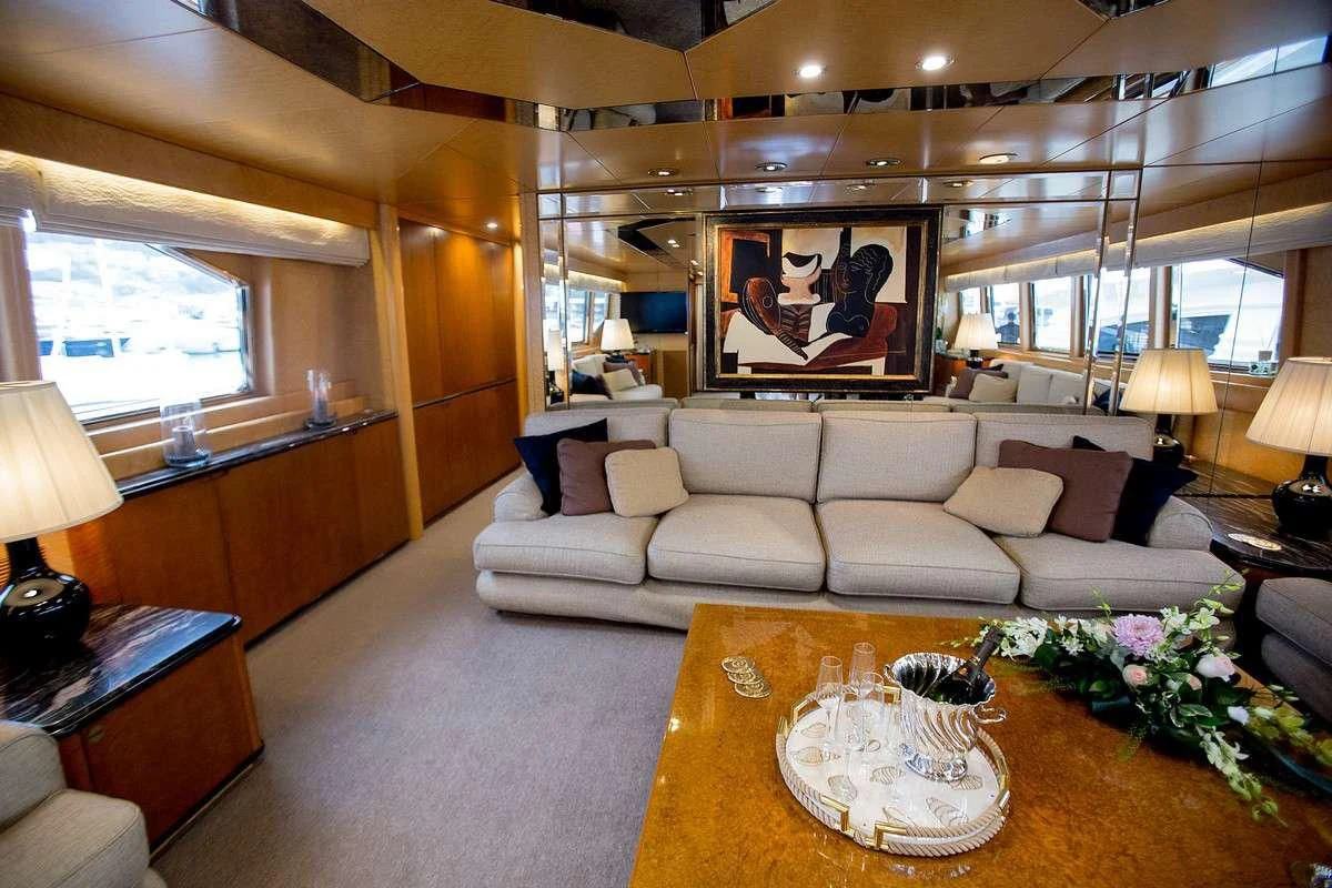 a living room with a white couch aboard LADY RINA Yacht for Sale