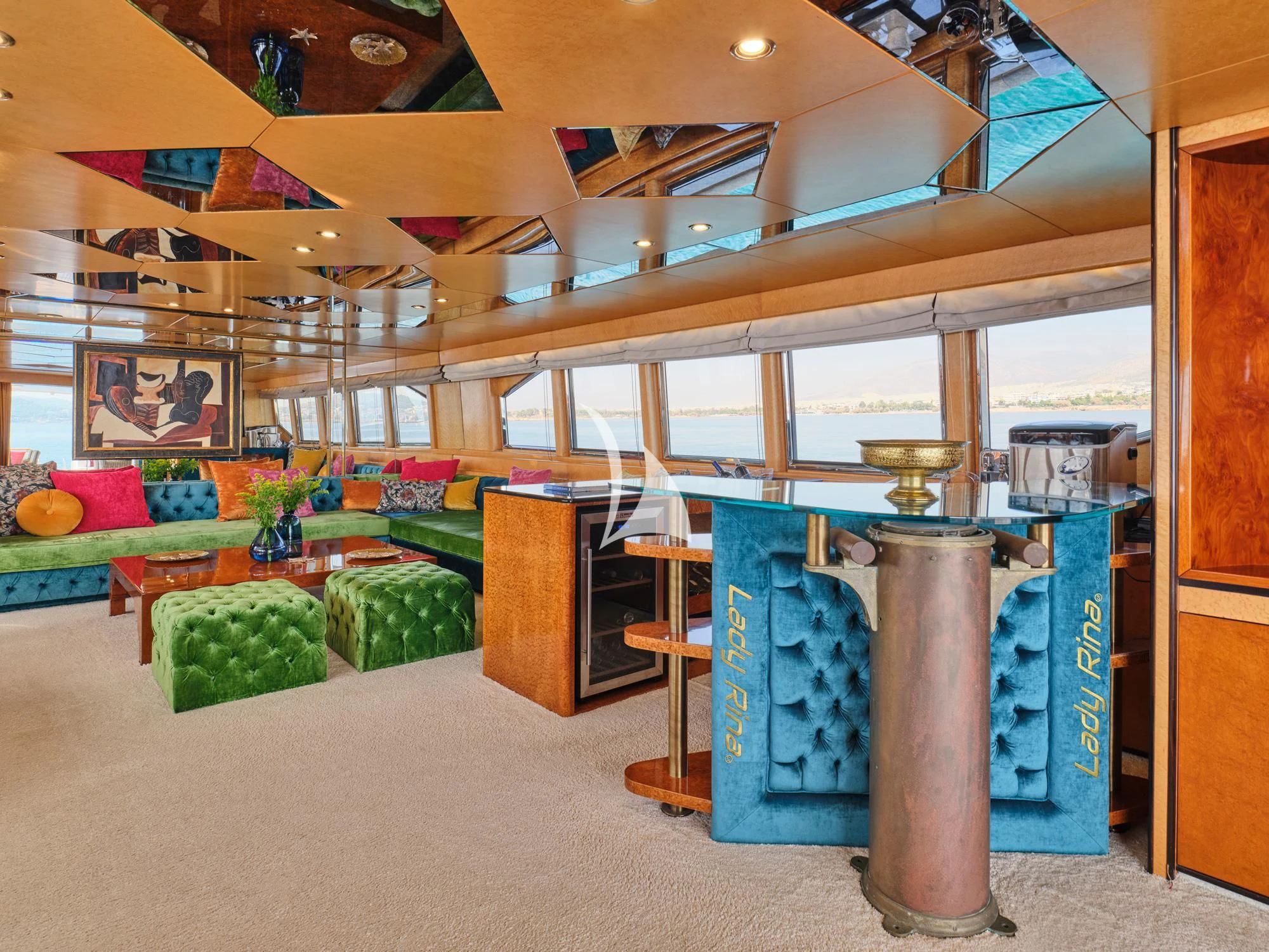 a room with a large blue table and chairs aboard LADY RINA Yacht for Sale