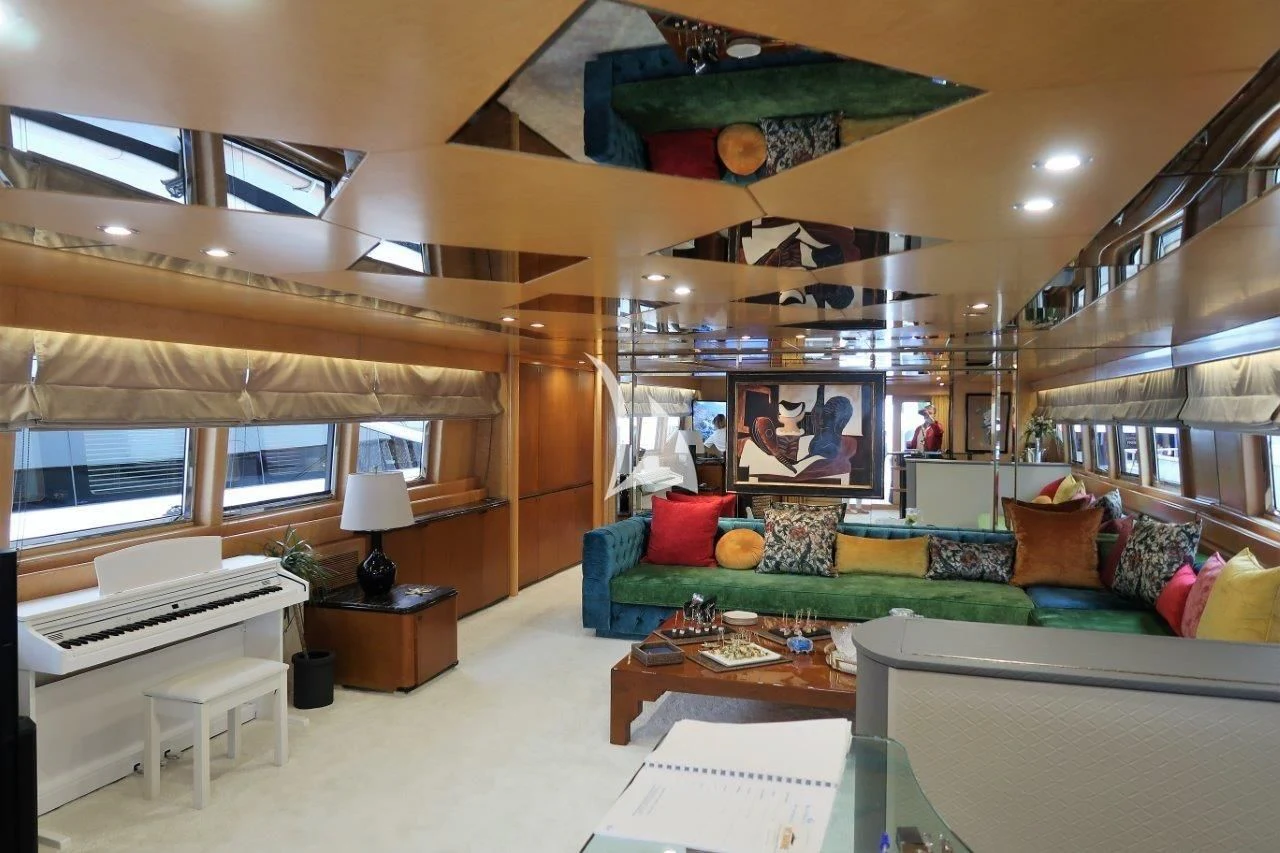 a living room with a couch and a table aboard LADY RINA Yacht for Sale