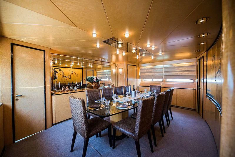 a dining room with a table and chairs aboard LADY RINA Yacht for Sale