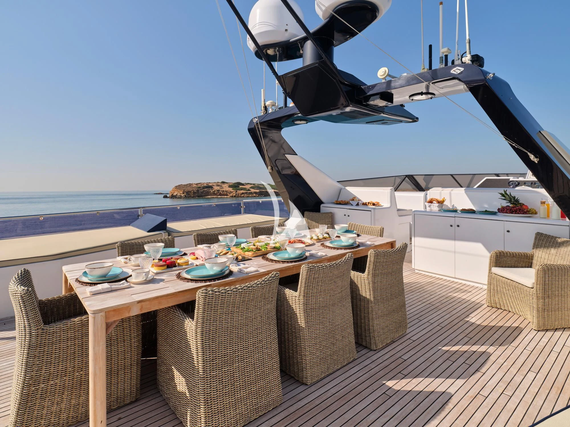 a table and chairs on a deck aboard LADY RINA Yacht for Sale