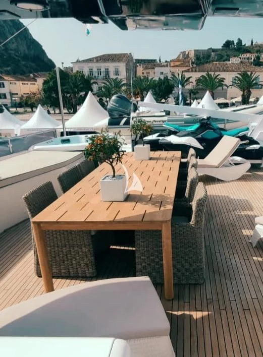 a table with chairs on it aboard LADY RINA Yacht for Sale