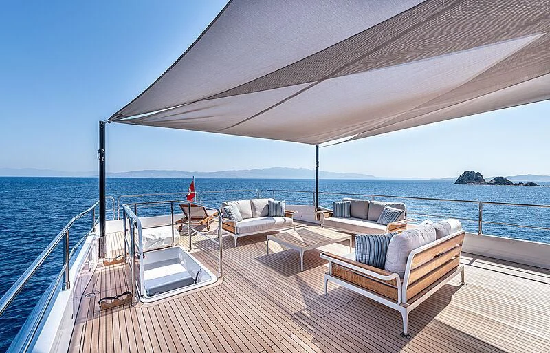 a deck with chairs and a large body of water aboard TUBABU Yacht for Sale