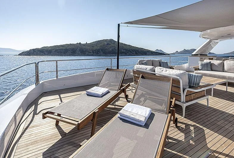 a deck with a table and chairs on it aboard TUBABU Yacht for Sale