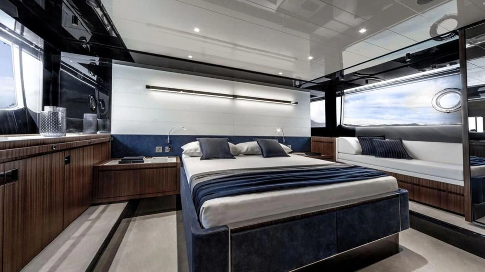 a room with a bed and a window aboard 66' RIBELLE Yacht for Sale