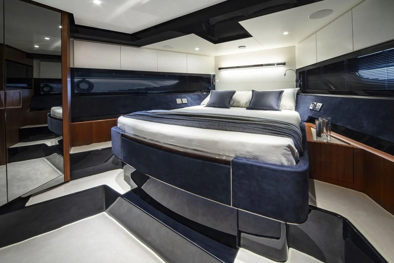 a room with a bed and a mirror aboard 66' RIBELLE Yacht for Sale