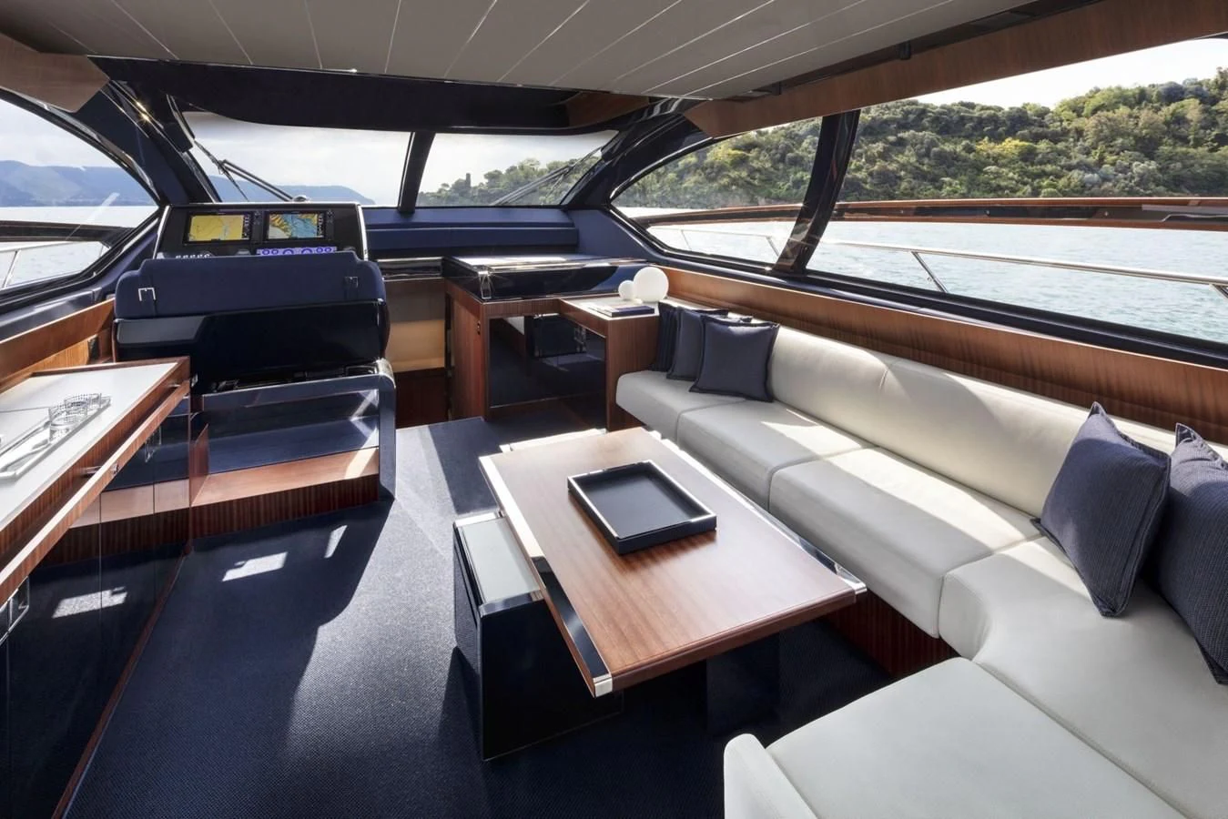 a car with a table and a laptop on a table aboard 66' RIBELLE Yacht for Sale