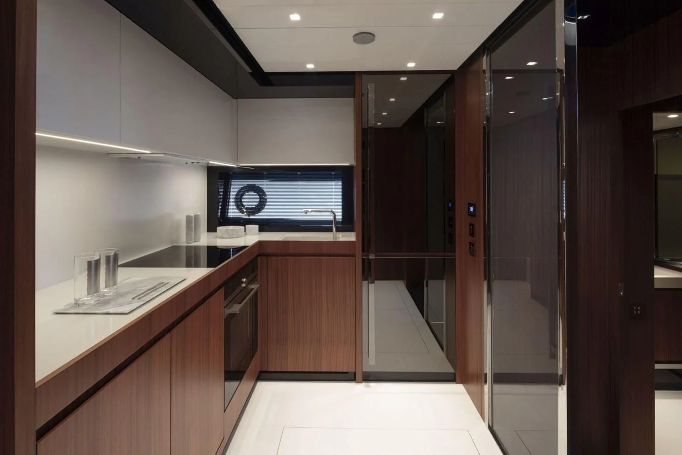 a kitchen with a large refrigerator aboard 66' RIBELLE Yacht for Sale