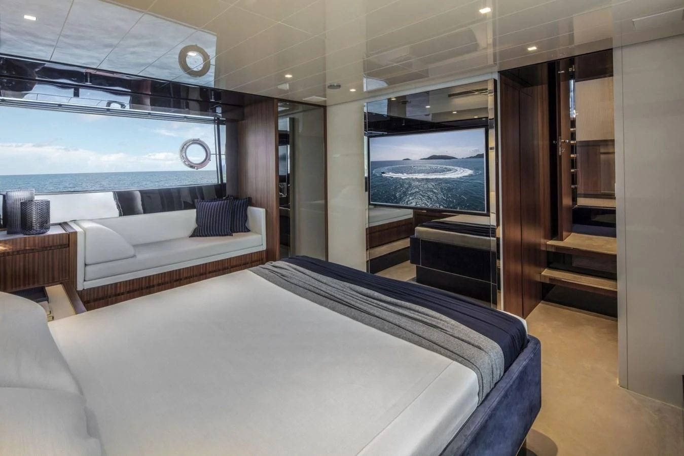 a room with a bed and a large window aboard 66' RIBELLE Yacht for Sale