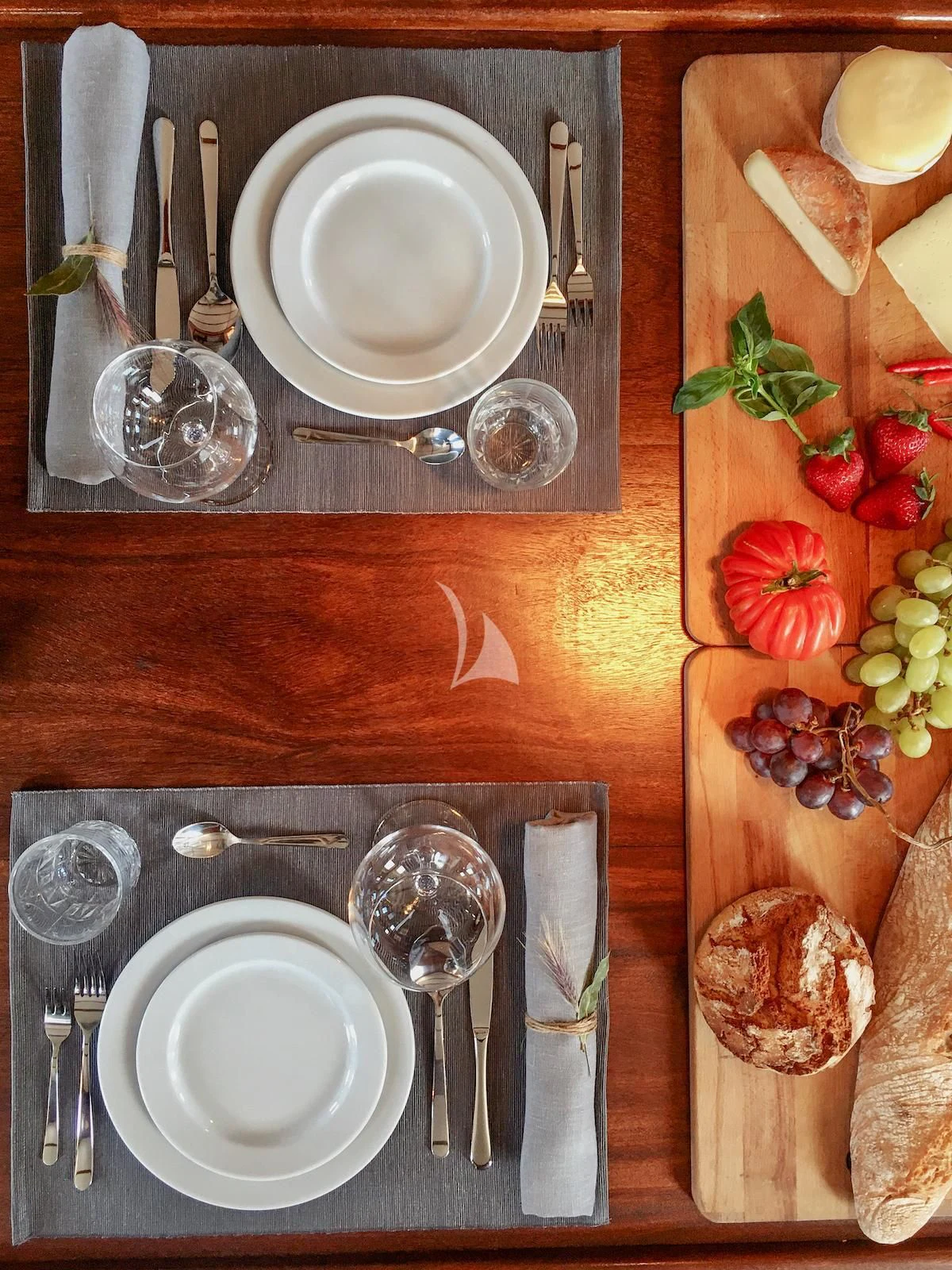 a table with plates and silverware aboard BALTO Yacht for Sale