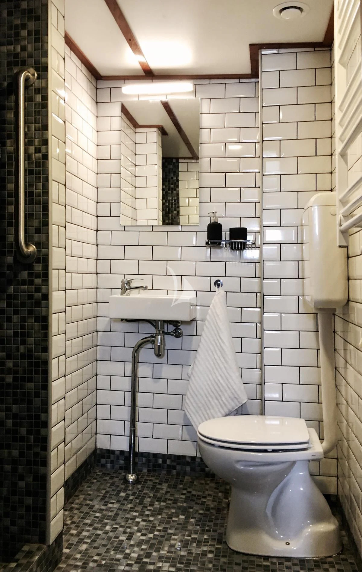 a bathroom with a toilet sink and mirror aboard BALTO Yacht for Sale