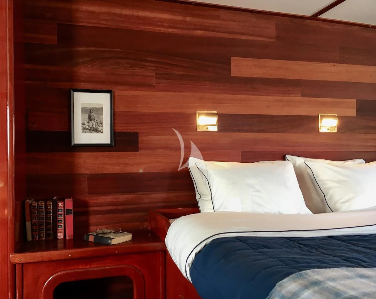 a bed with a white pillow aboard BALTO Yacht for Sale