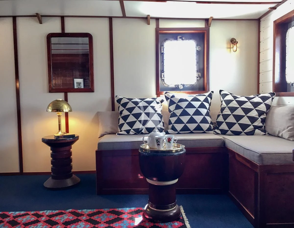 a living room with a couch and a table aboard BALTO Yacht for Sale