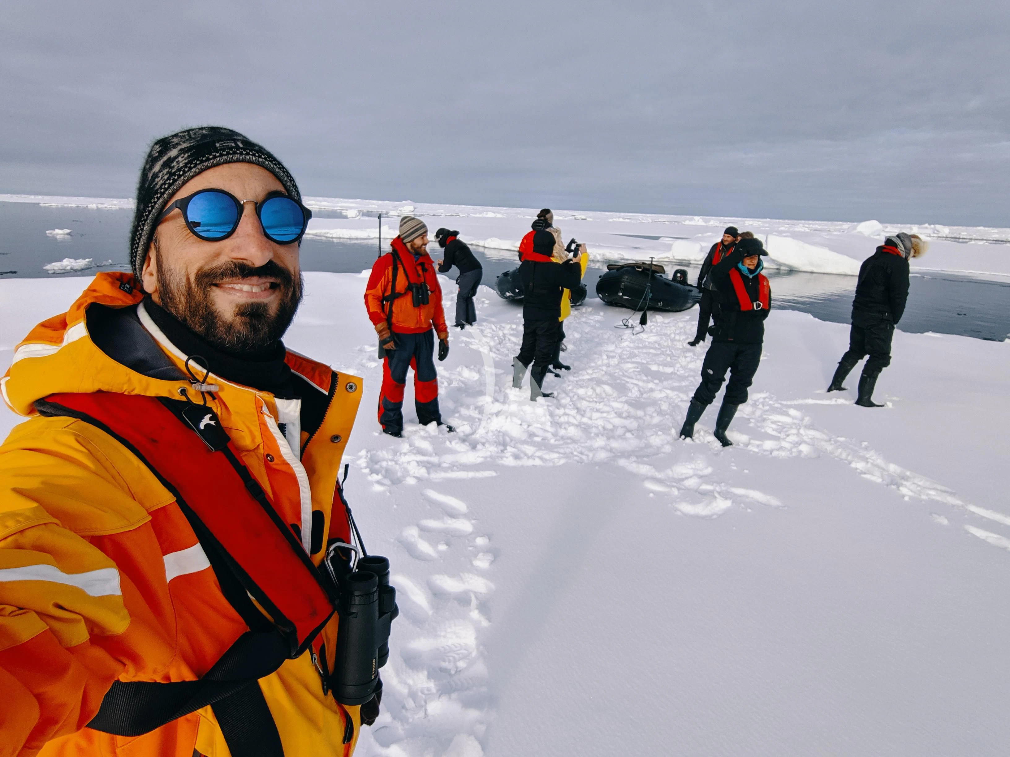 a man in sunglasses and a backpack on a snowy mountain aboard BALTO Yacht for Sale
