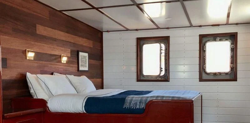 a bed in a room aboard BALTO Yacht for Sale