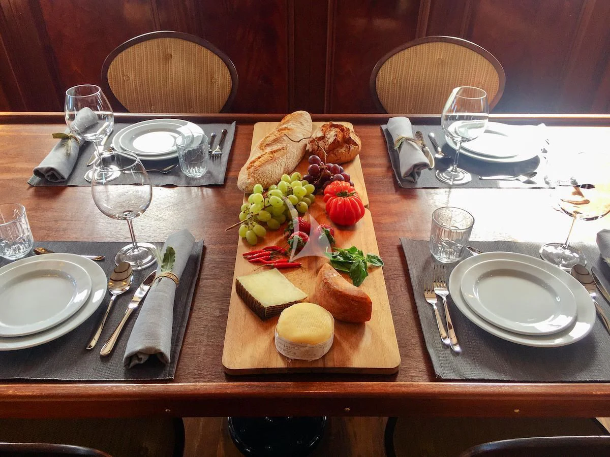 a table with food and plates aboard BALTO Yacht for Sale