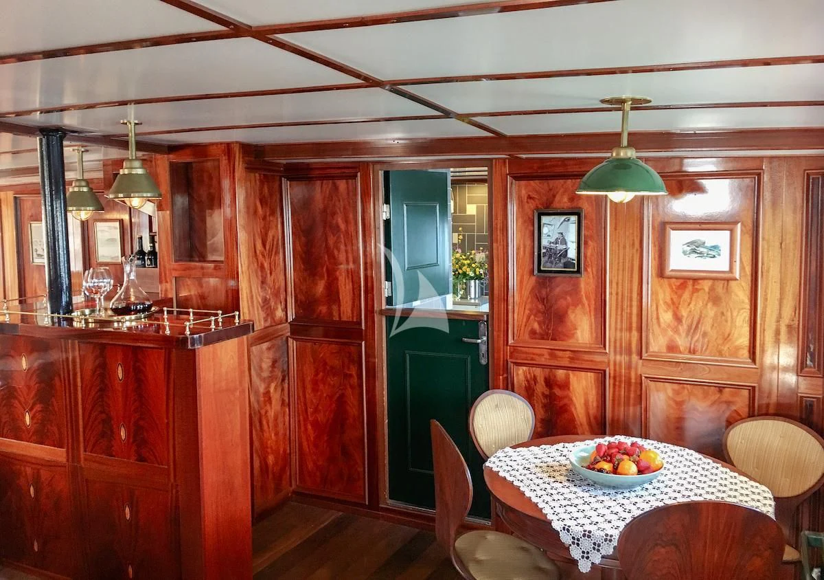 a dining room with a table and chairs aboard BALTO Yacht for Sale