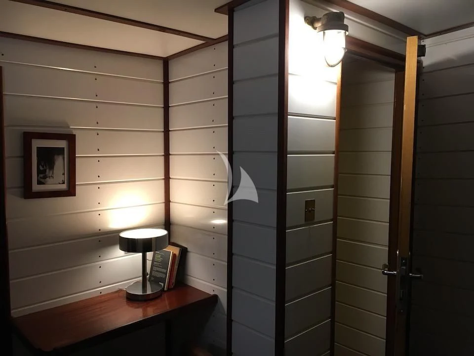 a room with a mirror and a shelf with a lamp on it aboard BALTO Yacht for Sale