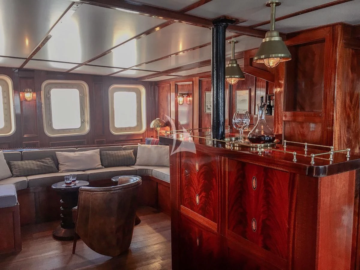 a room with a couch and a table aboard BALTO Yacht for Sale